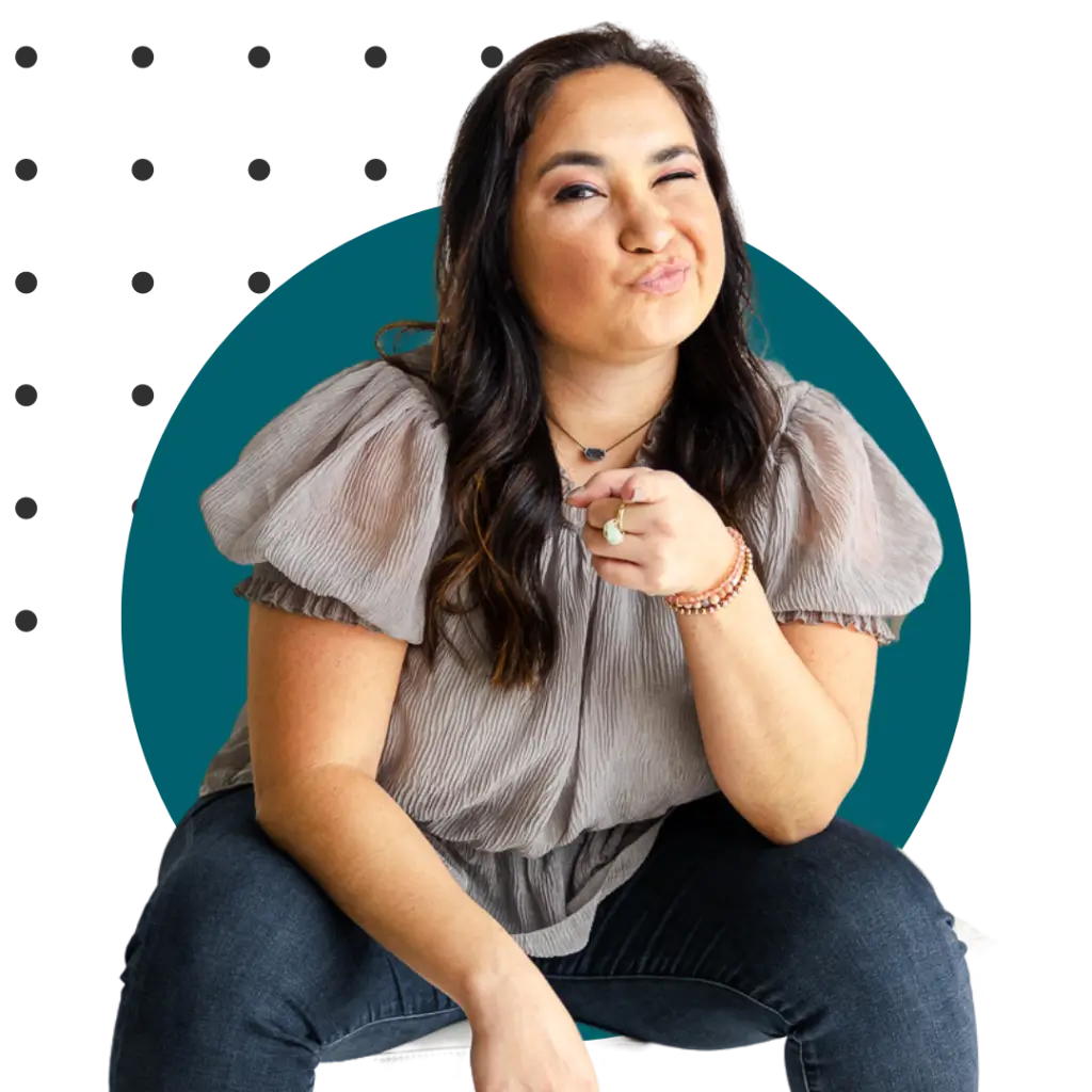 Legalpreneur founder smiling and pointing while seated in a casual pose